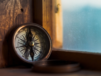 Open compass sitting on a windowsill