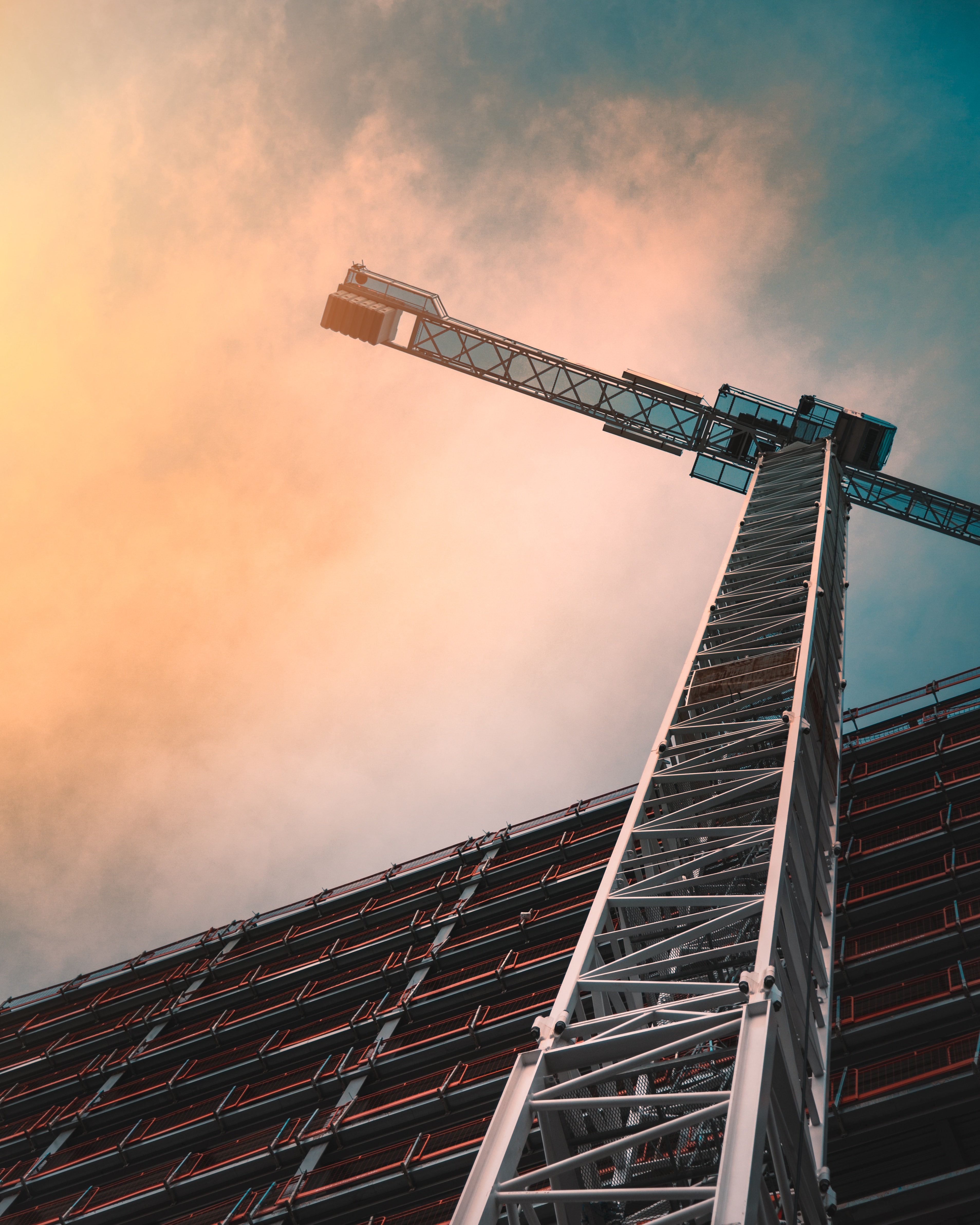 Low angle shot of a crane in front of a building.