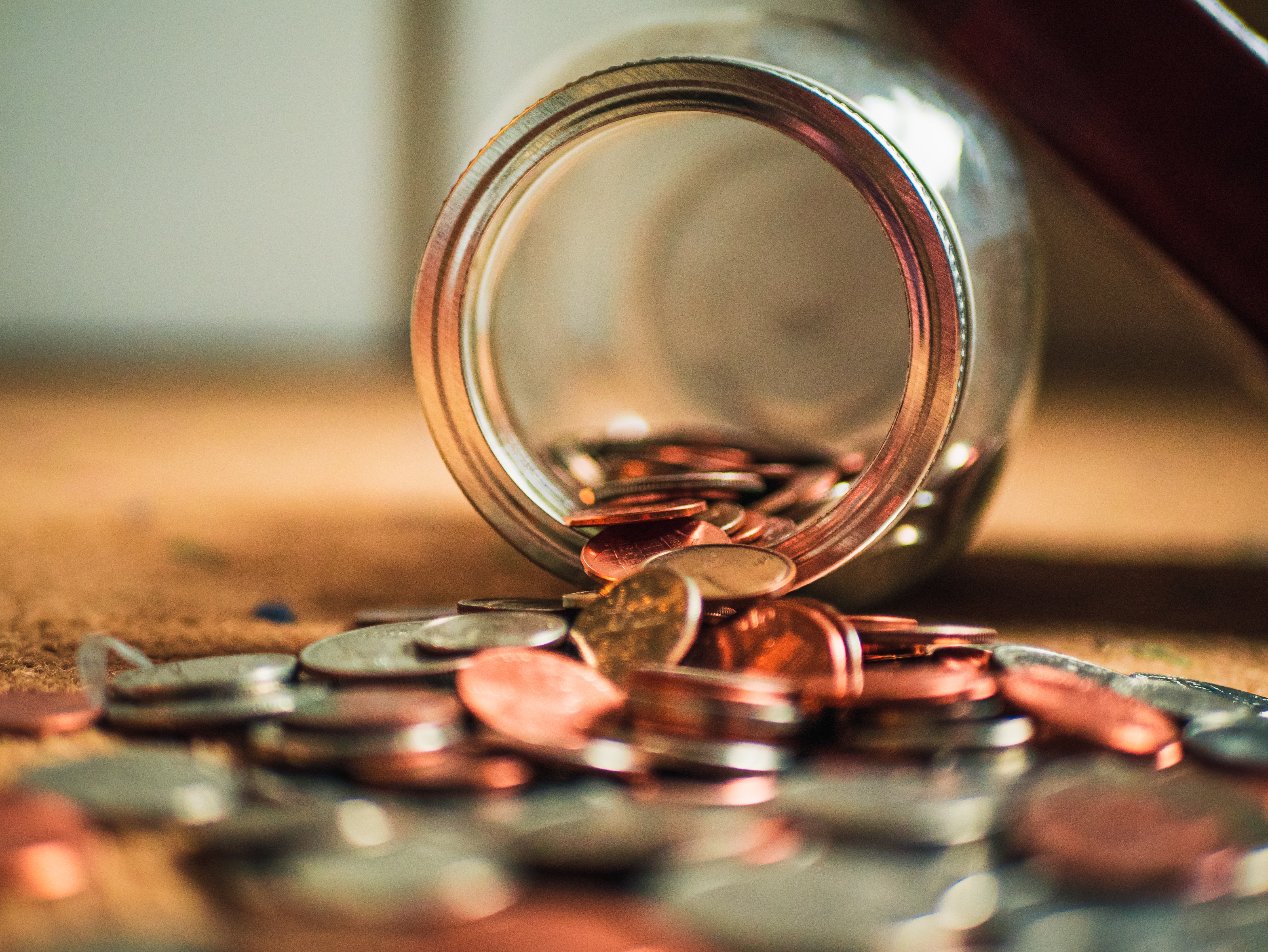 Coins spilling out of a jar