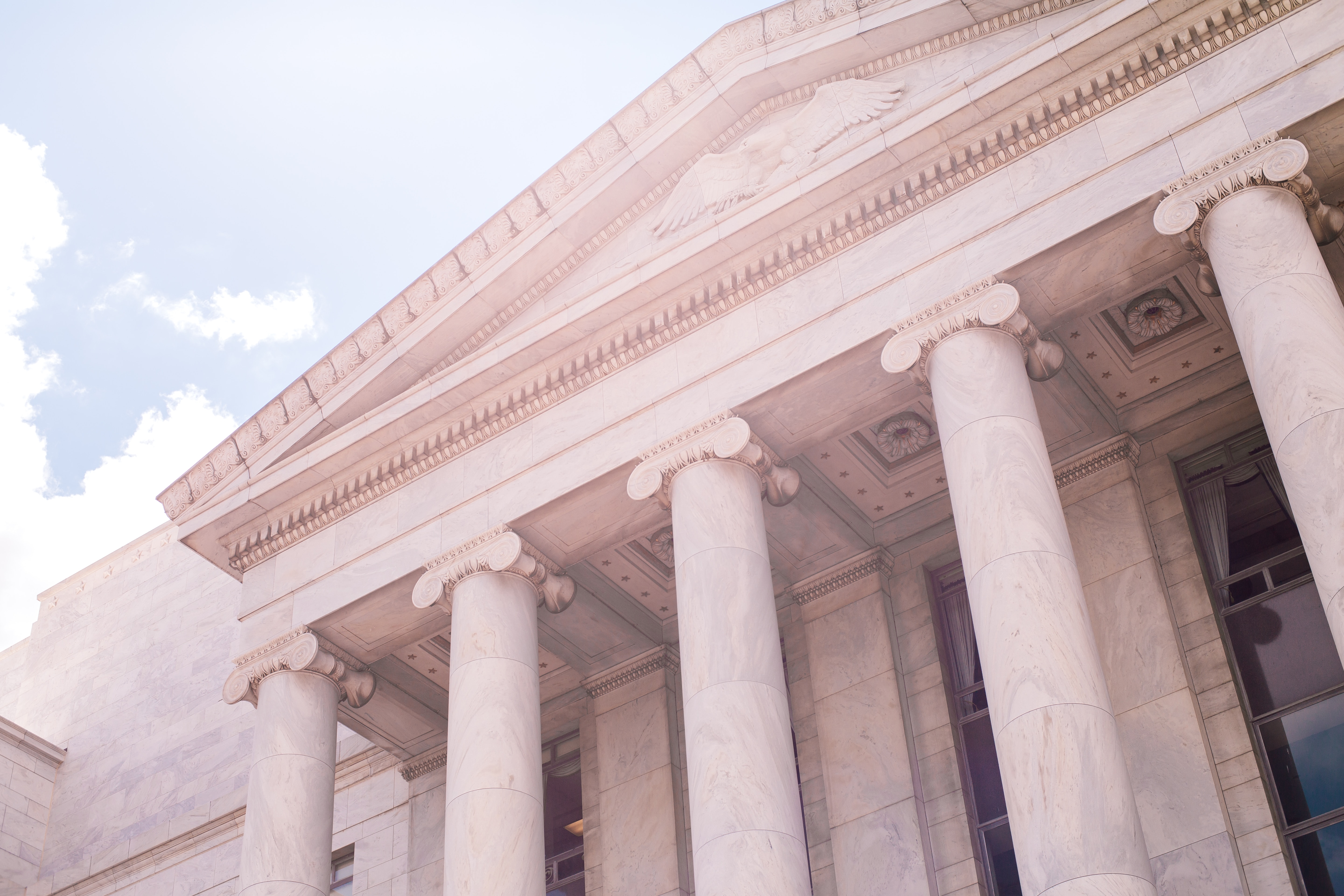 Exterior of a white building with columns